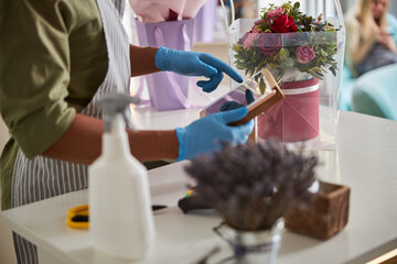 Flower store salesman tapping on a tablet screen