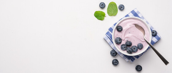 Blueberry yogurt with fresh berries on white background. Healthy breakfast