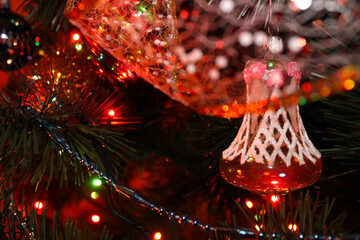 Christmas-tree decoration "Bell" hanging on the branch of a Christmas tree. Christmas toy hanging on the tree.