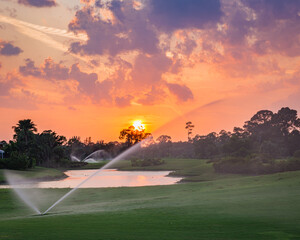 Golf course sunset with sprinklers in the sunset. South Florida.
