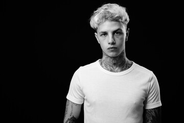 Naklejka premium Young handsome rebellious man with blond hair in black and white