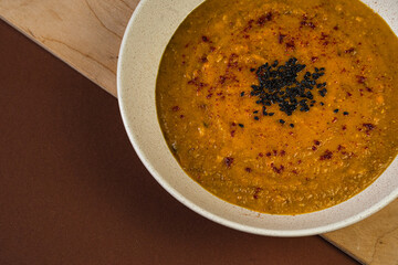 A healthy pumpkin cream soup for inner heat. A photo for a recipe article. Vegan food photography. Vegetarian meals. 
