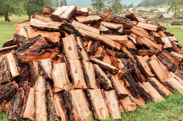 Firewood is stacked in autumn. Chopped pile of wood. Lots of wood from logs. Preparation of...
