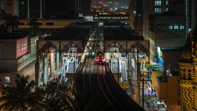 Medellin, Colombia, time lapse view of busy subway station showing trains arriving and departing in the evening.