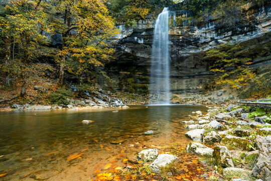 beautiful fall forest landscape with idyllic waterfall and pool
