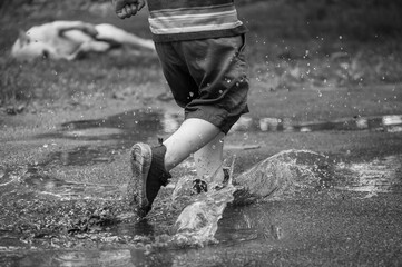 child walking in puddle