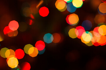 Christmas blurred background with colorful festive lights.