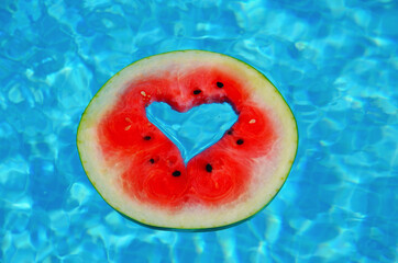 A heart shaped watermelon, floating in the blue waters of the Mediterranean Sea. 