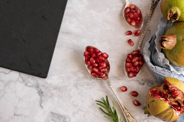 Ripe pomegranate seeds on marble background