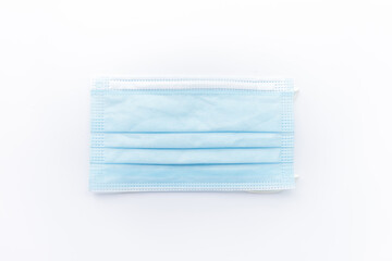 Fototapeta premium Surgical mask isolated on white background. Concept : Medical waste disposal during the novel COVID-19 pandemic.