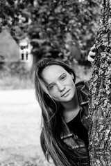Teen girl in the birch. Black and white photography.