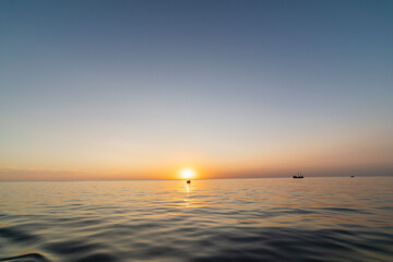 sunset at sea with boats