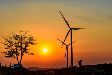 Wind turbine farm over sunset