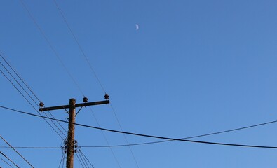 electricity pylons and moon