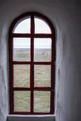 Fototapeta premium Rustic red wooden window in thick wall