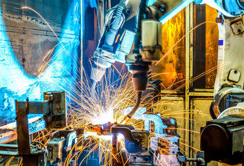 robots welding in a car factory