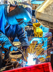 worker with protective mask welding metal industry