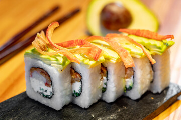 sushi roll with avocado topping