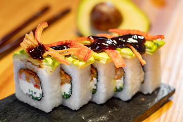 sushi roll with avocado topping