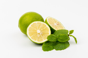 Lime with mint leaves isolated on white background.