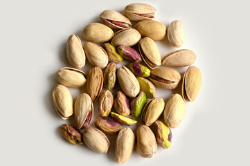Pistachios in walnut shell on white background, composition of pistachios excellent for a healthy and dietetic diet,antioxidant food