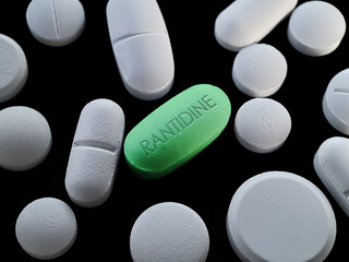 Ranitidine Green tablet pill on black background