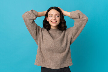 Teenager Ukrainian girl isolated on blue background laughing