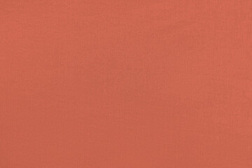 Fototapeta premium Coral homogeneous background with a textured surface, fabric.