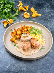 Modern style traditional barbecue pork filet medaillons in cream sauce with chanterelle mushrooms...