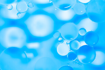 Blue glitter vintage lights background. Blue texture background. Oil drops in water.