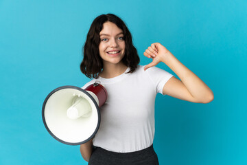 Teenager Ukrainian girl isolated on white background holding a megaphone and proud and self-satisfied