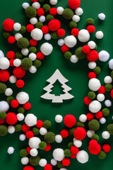 Christmas composition. Christmas tree and pompons on a green background. Christmas, winter, new year concept. Flat lay, top