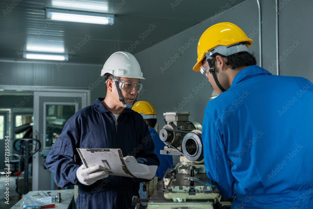 Poster mechanic working in the factory,the industrial worker team is working at a industrial factory.