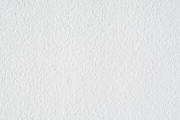 Uniform white roughly textured wall 