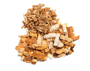 Various chips for smoking meat and fish isolated on white background top view. Heaps of wood chips from apple, pear and oak.