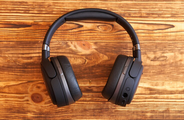 Headphones for gaming and listening music on a wooden background