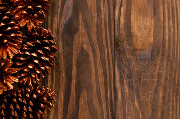 Christmas or New Year decoration background: with pine, on rustic and dark wooden background and with space for text. Minimalist background. Top view