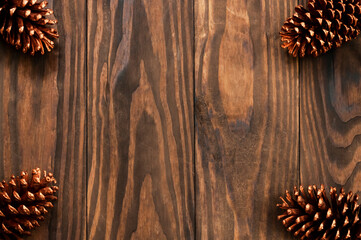 Christmas or New Year decoration background: with pine, on rustic and dark wooden background and with space for text. Minimalist background. Top view