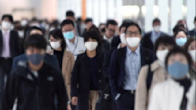 Covid-19 : Crowd of people wearing masks walking to work in Tokyo, JAPAN / slow motion
