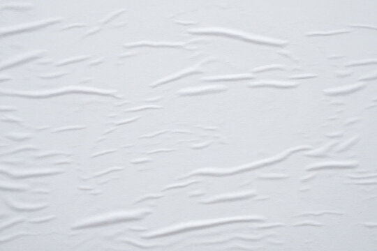Blank white crumpled and creased paper poster texture background © Piman Khrutmuang