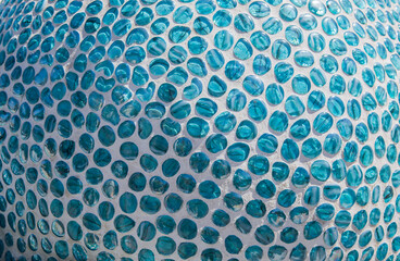 blue glass pebbles cemented on a spherical surface
