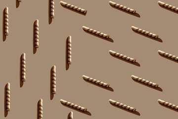 Seamless pattern of wafer rolls with trending hard shadows on a coffee background. Sweet food minimal concept