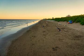 Landscape of La Lucila del mar beach at dusk, Buenos Aires. Few persons still enjoying the beach