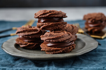 Christmas sandwich cookies filled with chocolate ganache.