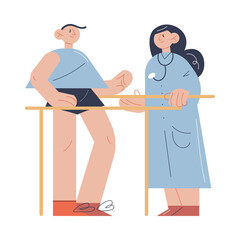 Woman therapist helping man patient with exercising during program of health rehabilitation