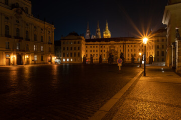 Fototapeta na wymiar lit street light in a city street at night. glowing lamp at night in the old town of prague in the czech republic and in the background the view of the city of Prague at night and the 