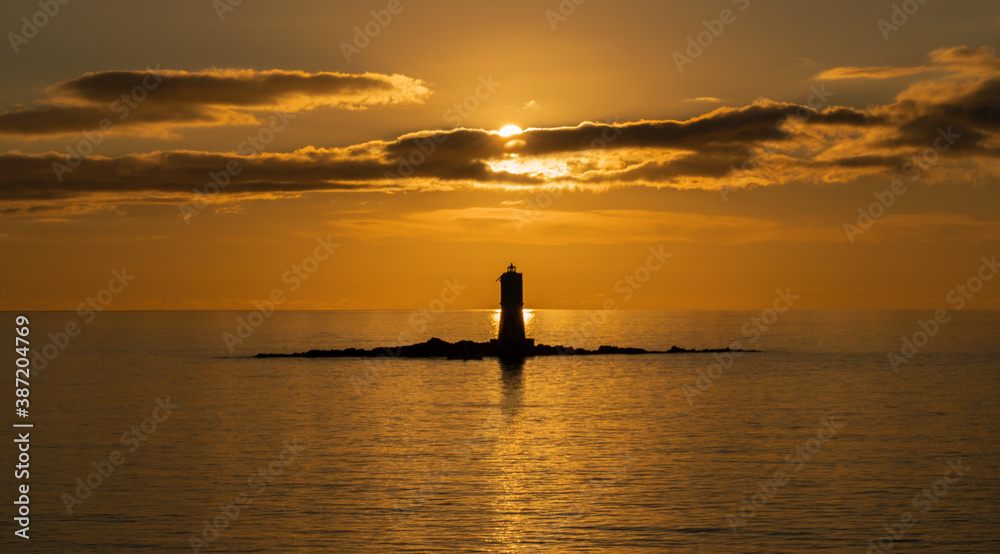 Poster the lighthouse of the Mangiabarche on a serene sunset,autumn day
