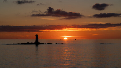 Fototapeta na wymiar the lighthouse of the Mangiabarche on a serene sunset,autumn day 