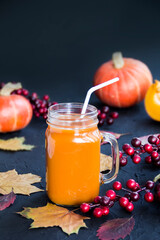 Halloween cocktail, pumpkin orange drink with spices. Dark vintage dirty background. Creative atmospheric decoration