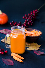 Halloween cocktail, pumpkin orange drink with spices. Dark vintage dirty background. Creative atmospheric decoration
